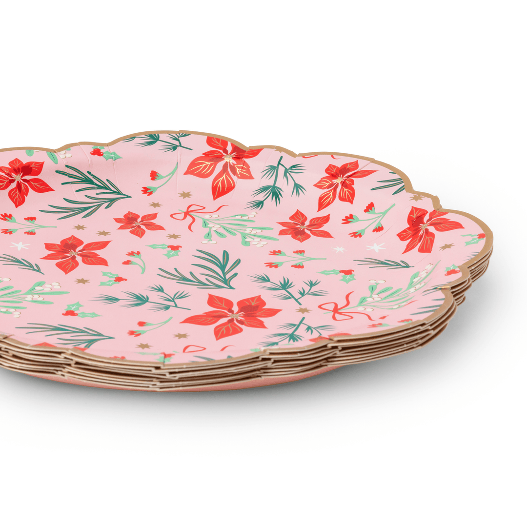Stack of pink Christmas floral dinner plates showing the classic rim design