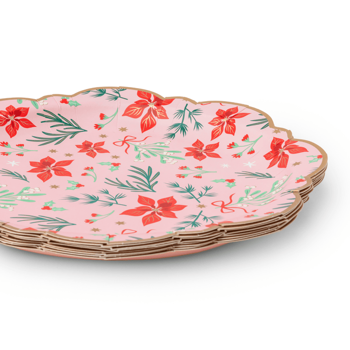 Stack of pink Christmas floral dinner plates showing the classic rim design
