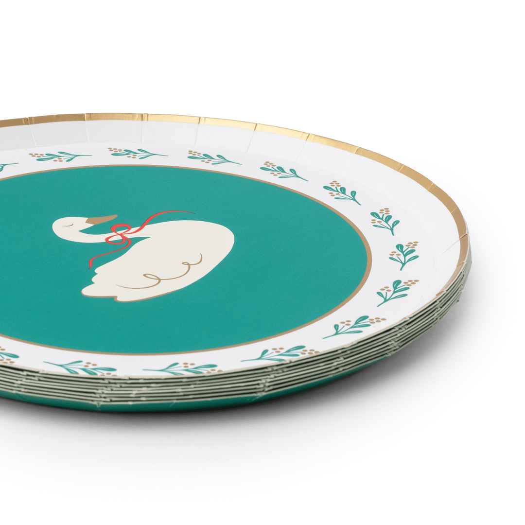 Stack of green Christmas swan print small plates showing the floral rim design