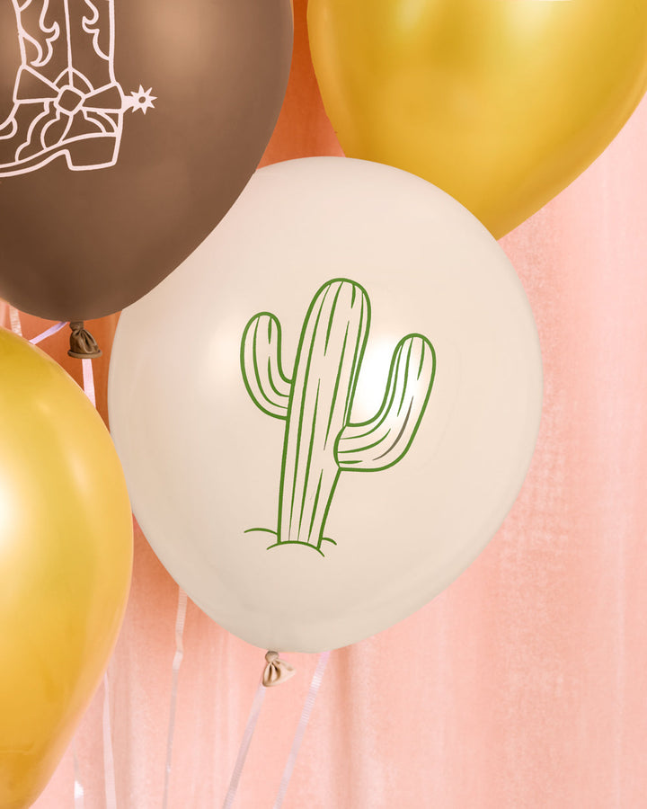 Cowboy latex balloons showing cow print, boot, horseshoe, and cactus designs