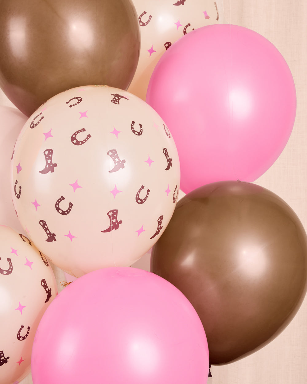 Detail of a cowgirl latex balloon with a pink cowboy boot print