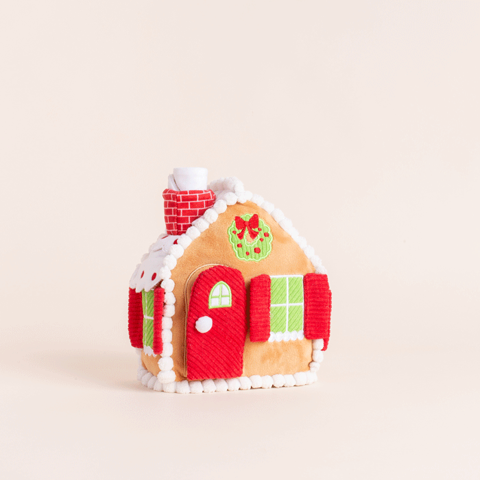 Animated clip of the gingerbread house dog toy on a cream backdrop