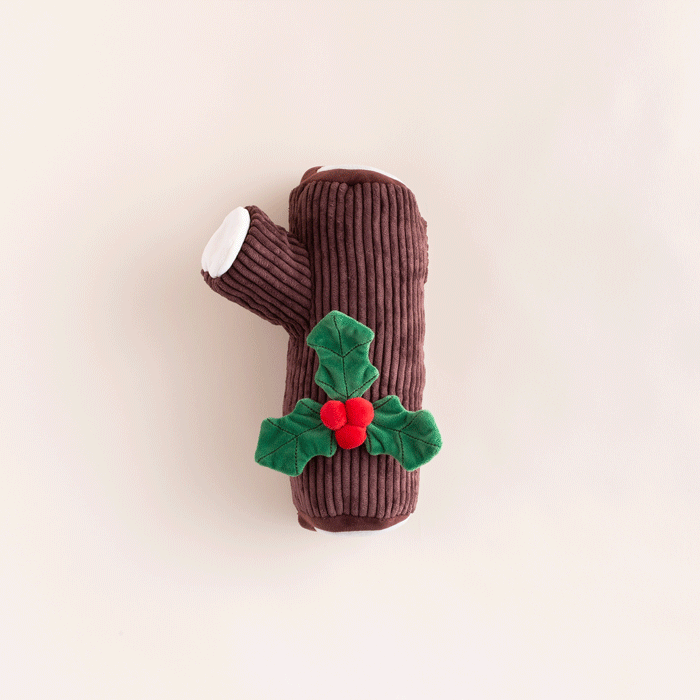 Animated clip of the yule log dog toy on a cream backdrop