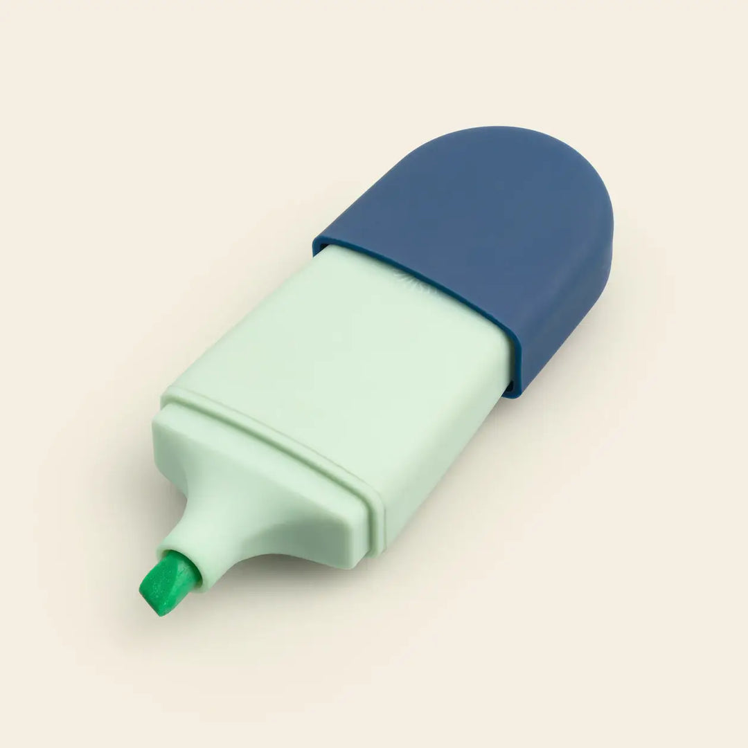 Mini highlighter with navy cap and mint body showing its green chisel tip, pocket sized for planners