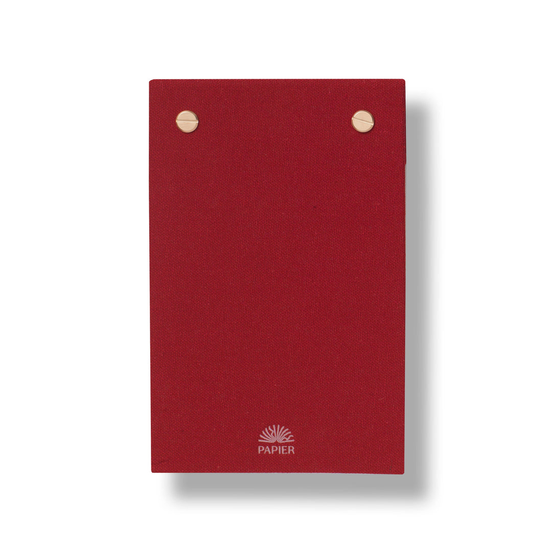 Back of the Bloom notepad in deep red linen with gold screws and Papier logo, giftable desk stationery