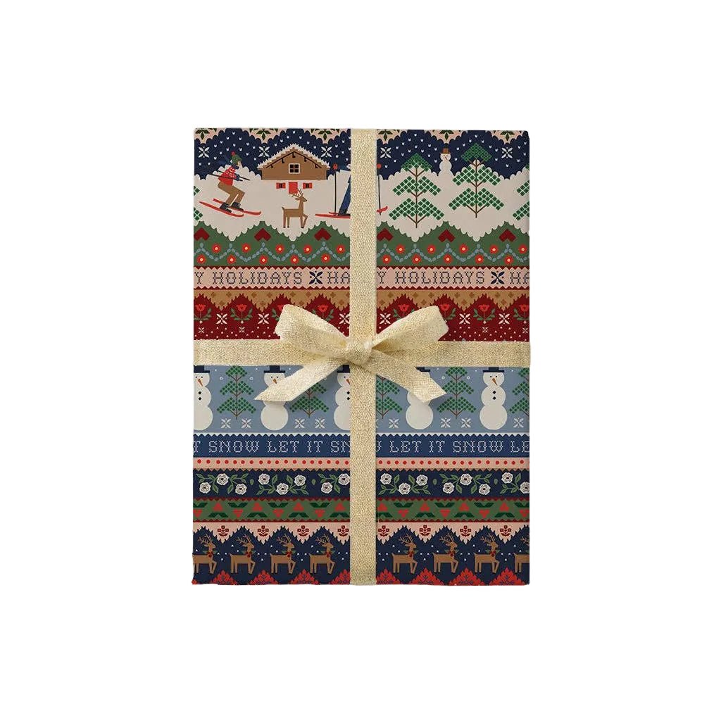 Ski Chalet Christmas wrapping paper roll shown wrapped with skiers, snowmen, and Happy Holidays knit bands