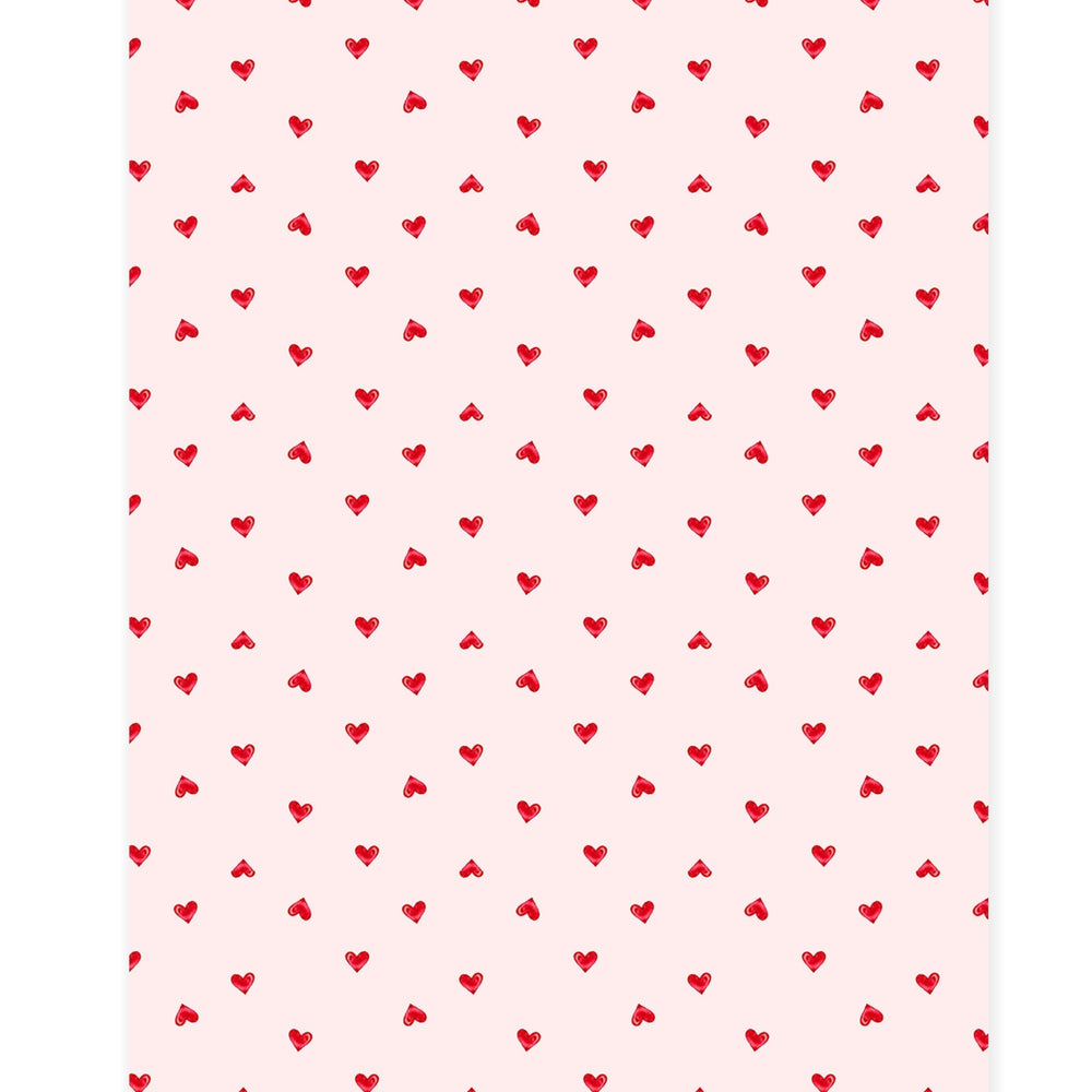 Close-up of the Ditsy Hearts print, tiny red hearts scattered on pale pink for Valentine's Day