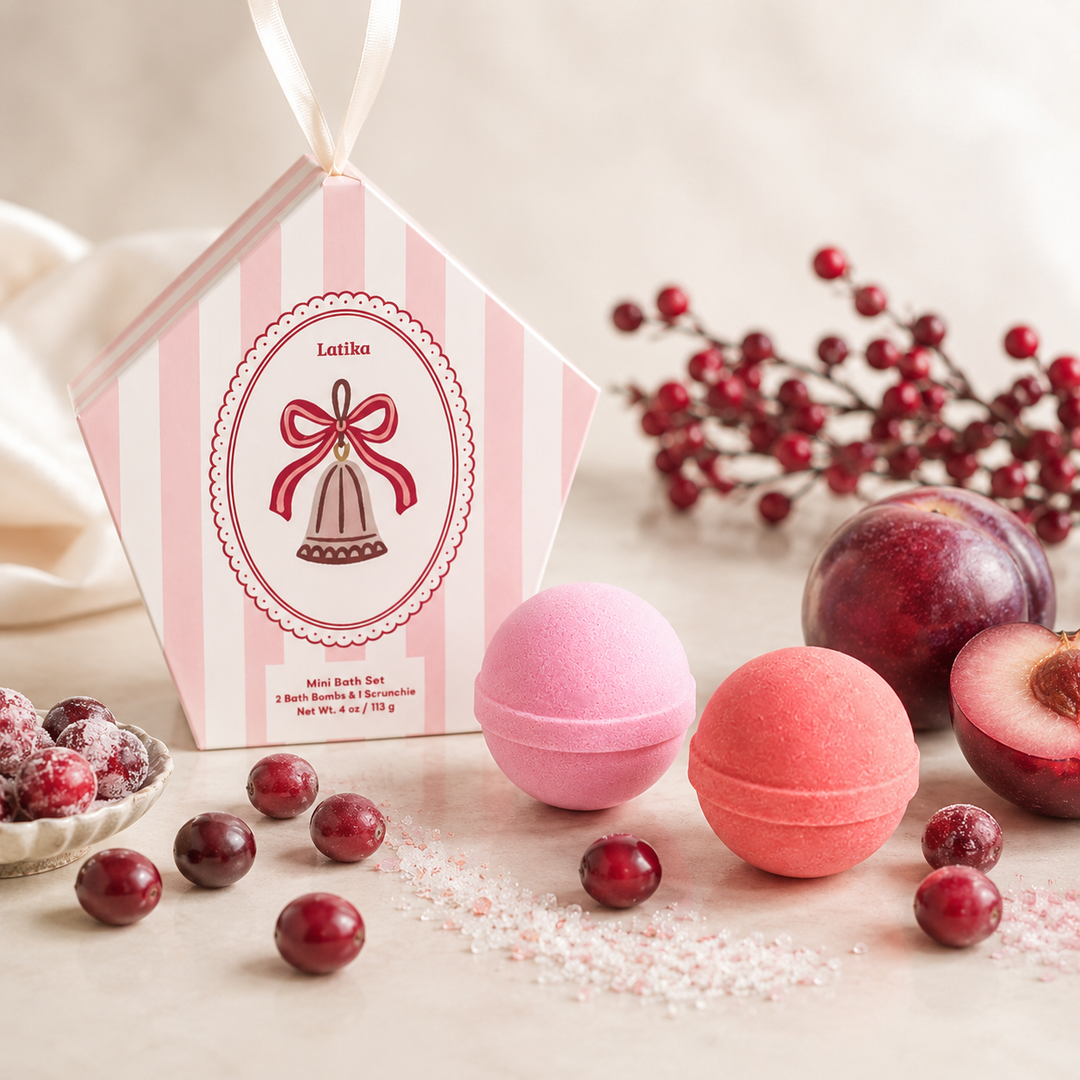 Bell ornament box with bath bombs beside sugared cranberries and plums, festive for a Christmas spa gift