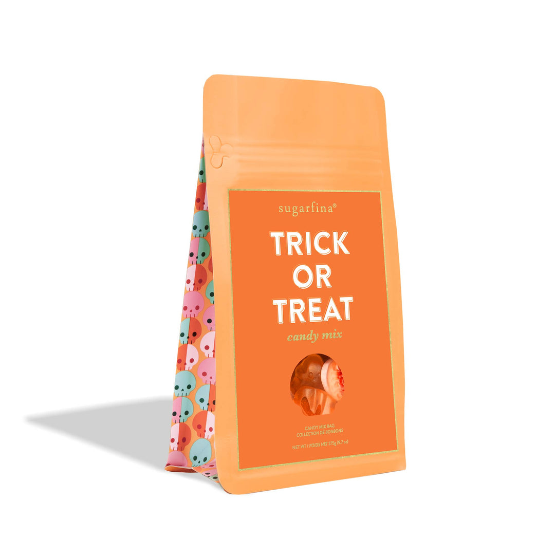 Orange bag of 'Trick or Treat' candy mix from sugarfina on a white background