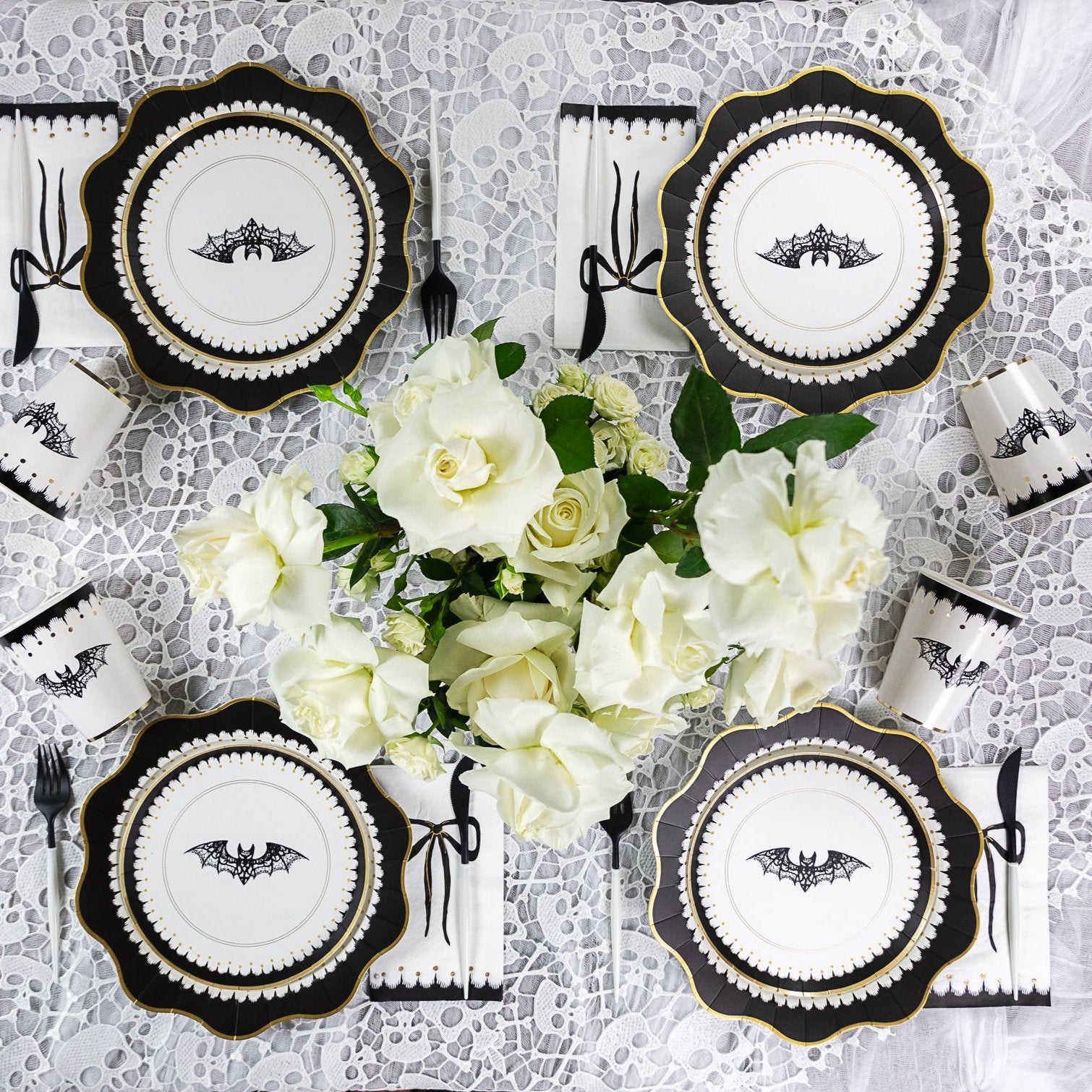 Elegant Halloween cups with black swags, gold bows, and lace bats for a chic Halloween party
