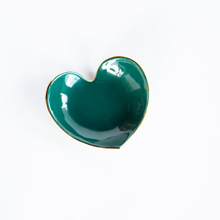 Emerald green heart ring dish with a glossy glaze and gold rim