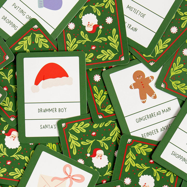 Christmas charades prompt cards with Santa hat, gingerbread man, and mistletoe for family game night