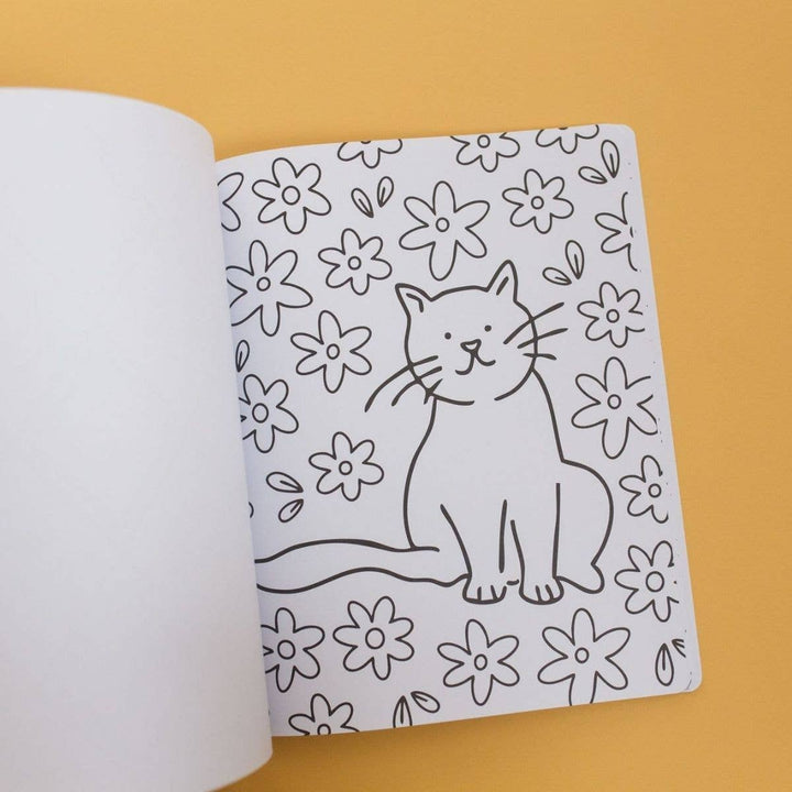 Coloring page of a sitting cat surrounded by daisies in the cat coloring book for kids