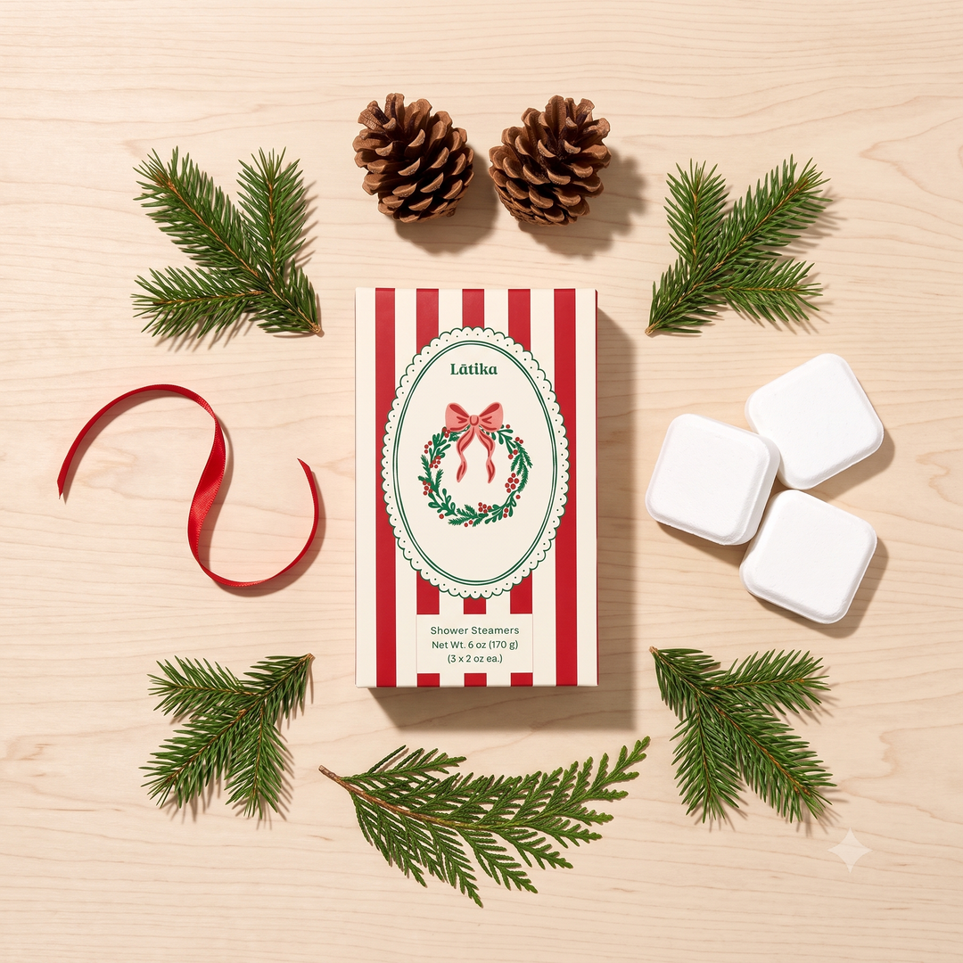 Wreath steamer box with cubes, pinecones and red ribbon arranged on light wood, festive holiday styling
