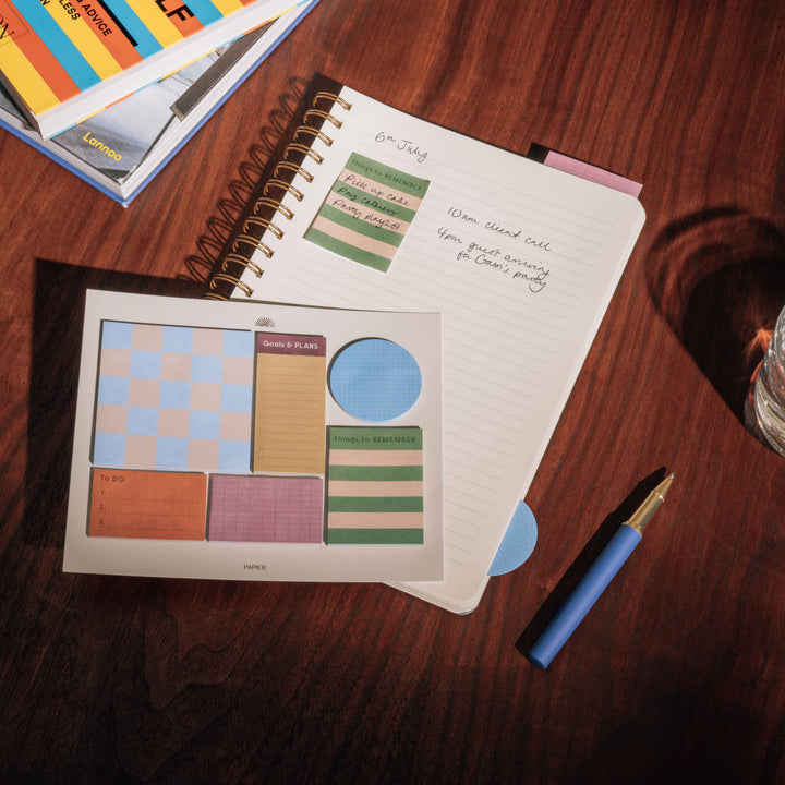 Green striped Things to Remember sticky note in a planner beside handwritten tasks, handy for busy desks