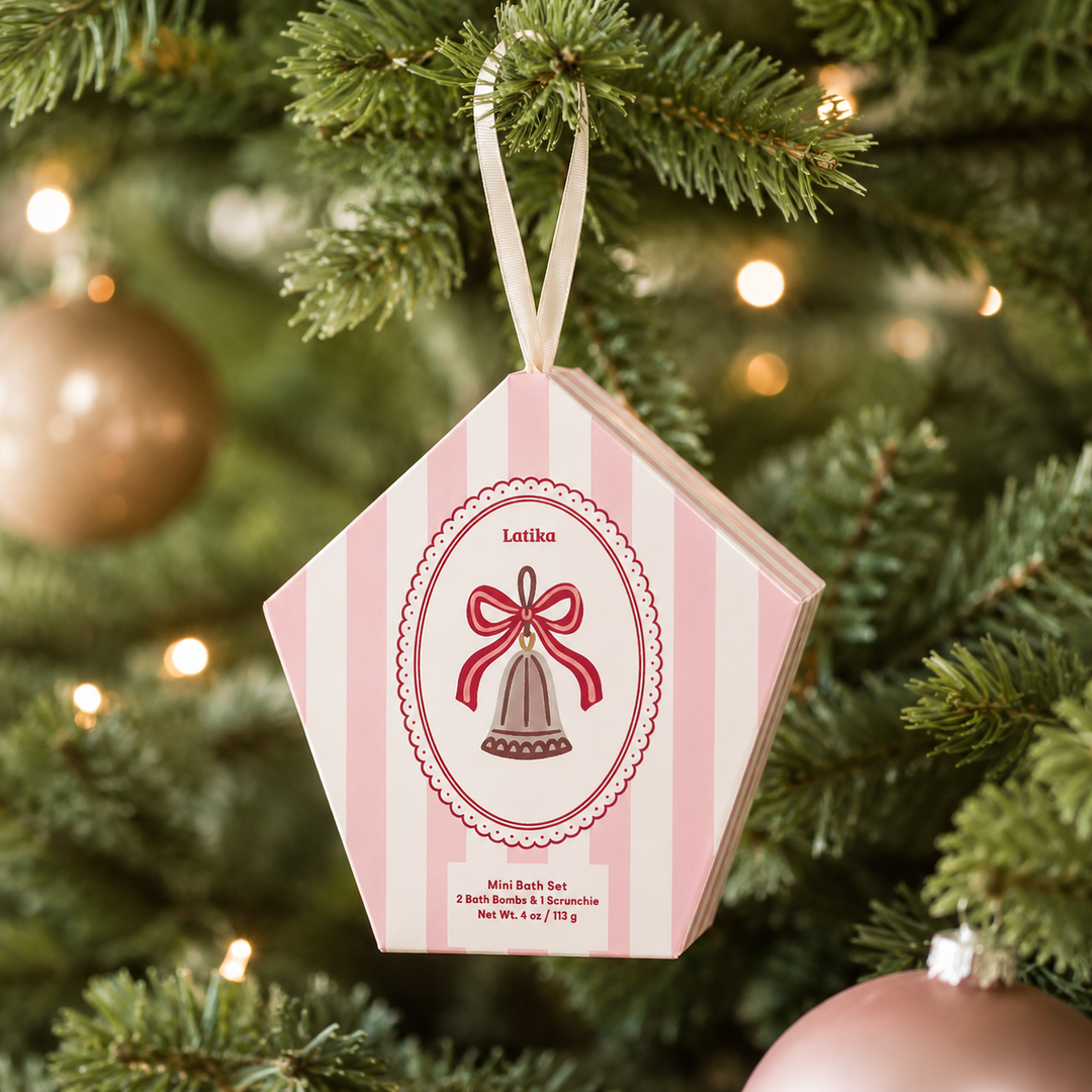 Pink striped bell ornament box hanging on a lit Christmas tree, a ready-to-hang stocking stuffer