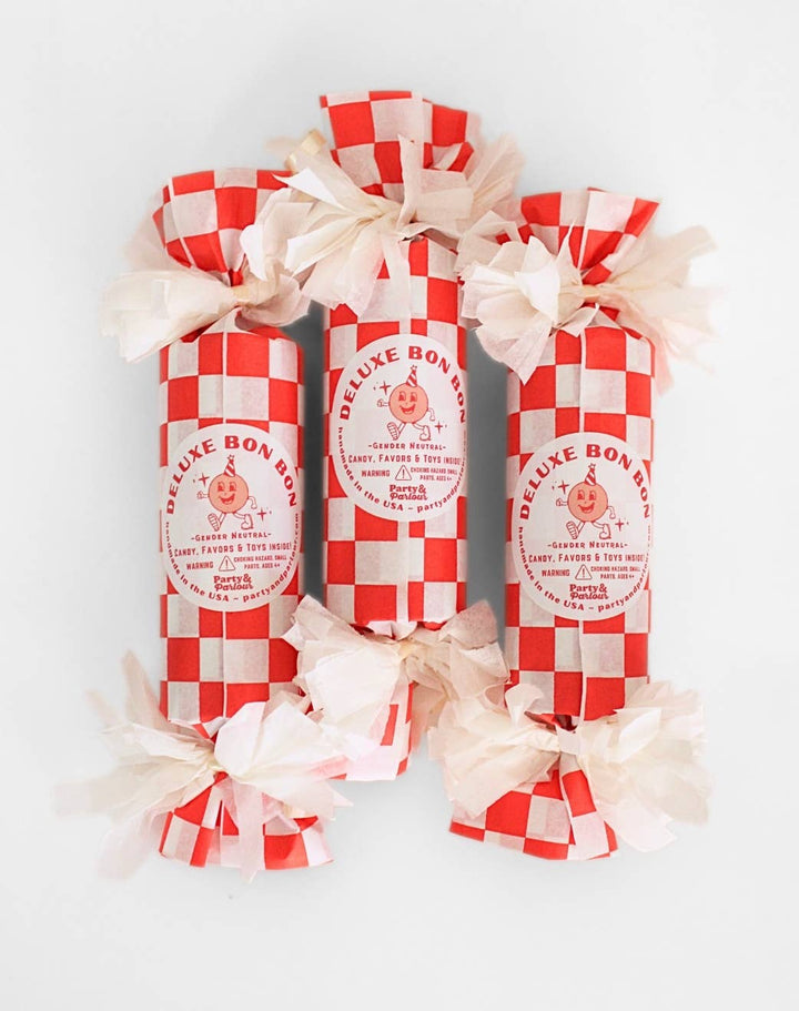 Three red and white checkered surprise bon bons with cream tissue ties for picnic party favors