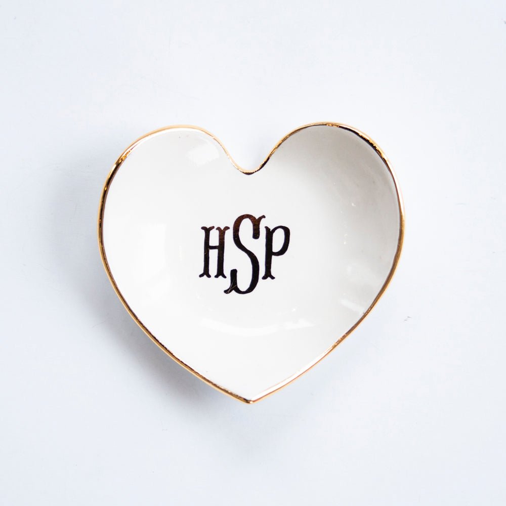 White heart dish personalized with a black HSP monogram and a gold rim