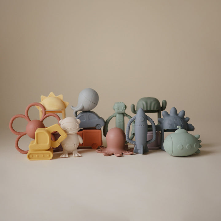Flat lay of the Mushie silicone rattle teethers