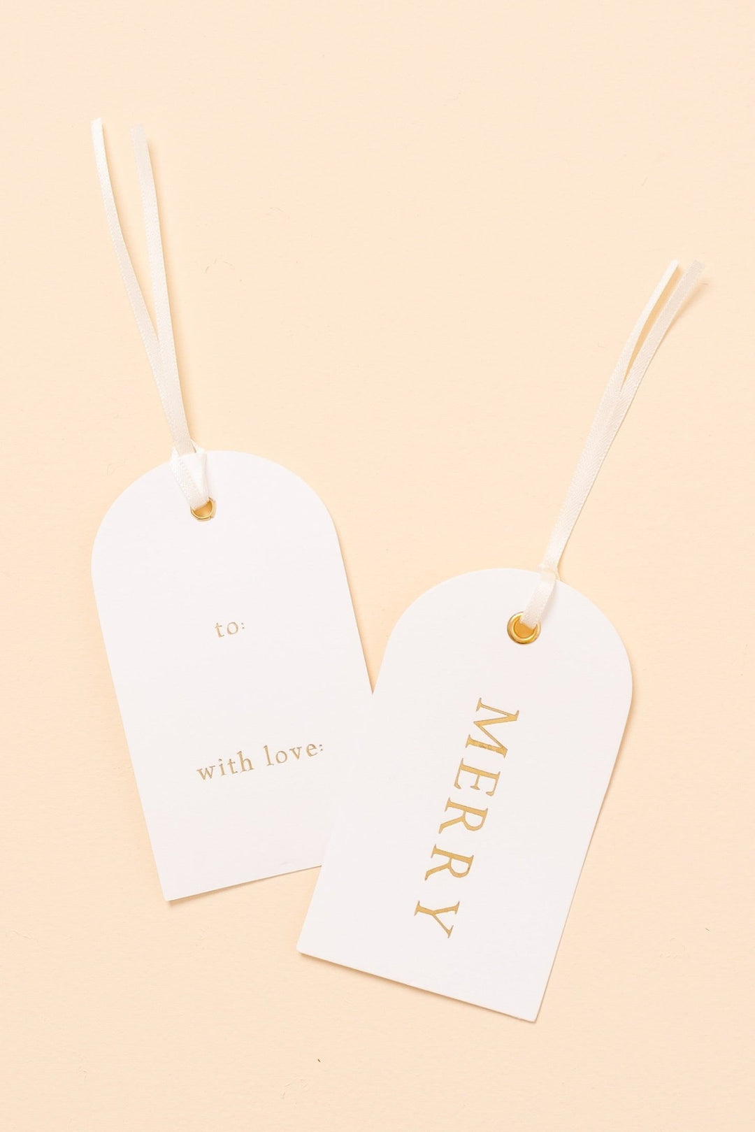 Two arch letterpress Christmas gift tags on cream: gold foil MERRY front, to and with love back