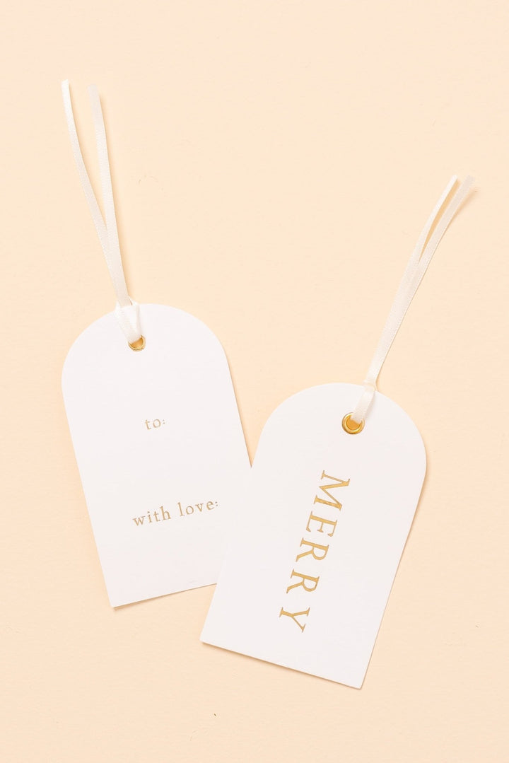 Two arch letterpress Christmas gift tags on cream: gold foil MERRY front, to and with love back