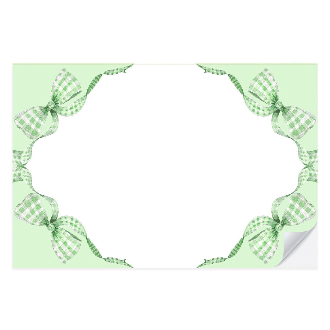 Green gingham paper placemat with a painted bow at the center, from a tear-off pad of 25