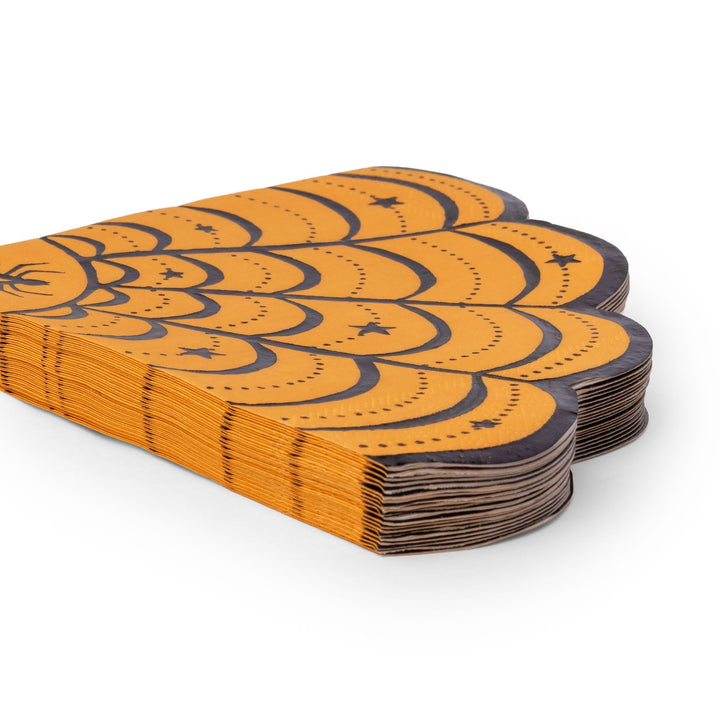Stack of Halloween spiderweb napkins showing the orange and black folded edges