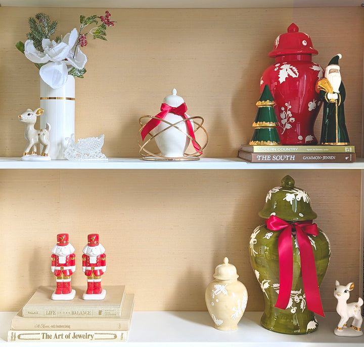 Decorative shelf with various ornaments including a red fire hydrant, green frog, and Santa Claus figurines.