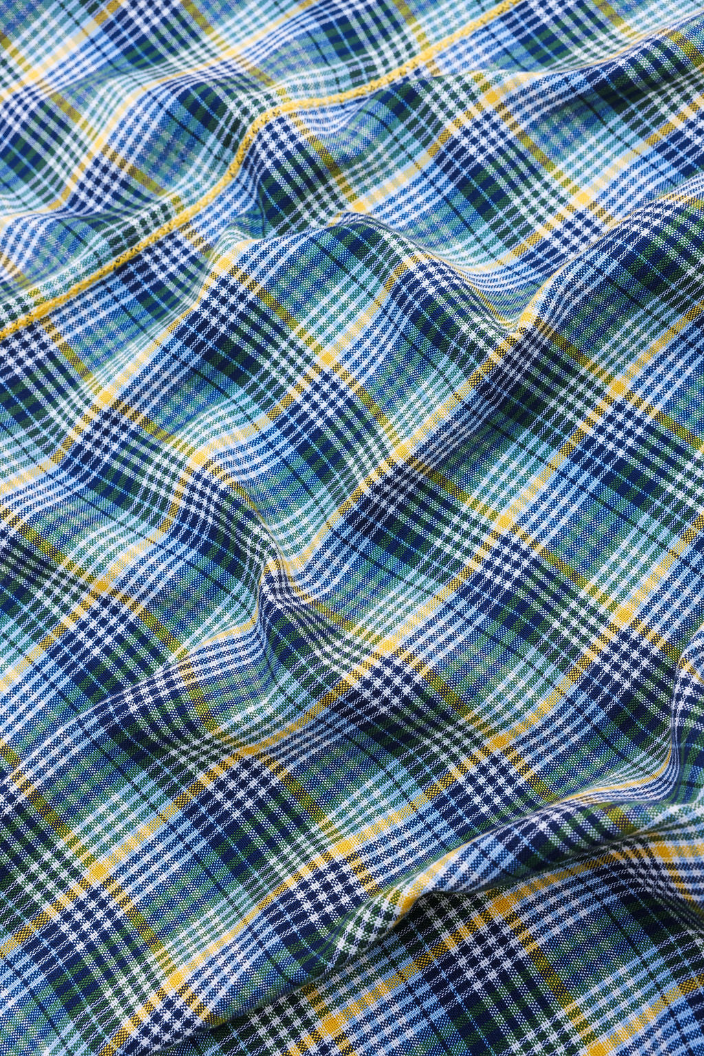 Close-up of the handwoven Maine plaid weave in navy, blue, yellow, and green on white
