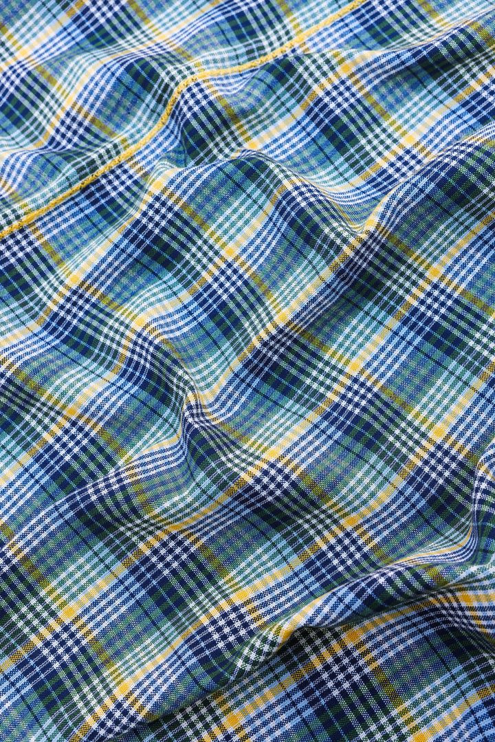 Close-up of the handwoven Maine plaid weave in navy, blue, yellow, and green on white