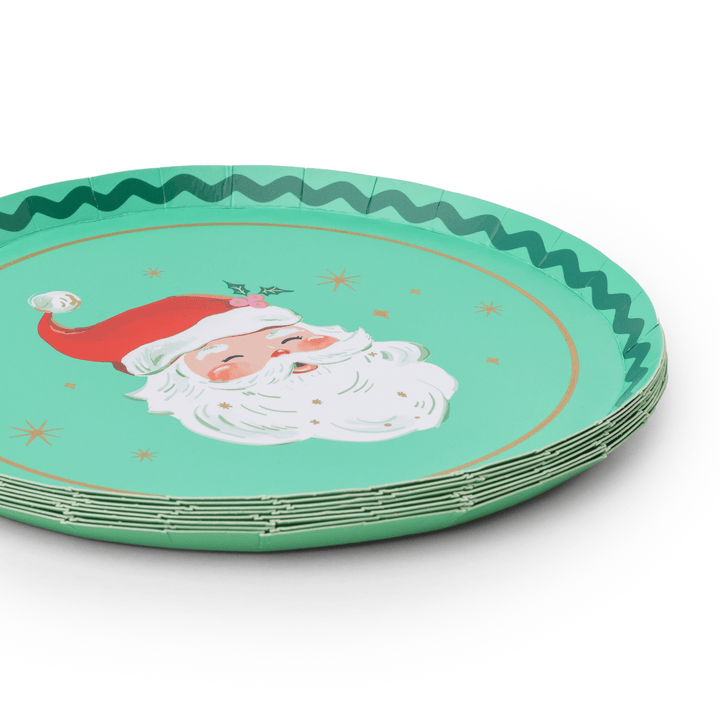 Stack of jolly Santa Christmas plates showing the red and green rim design