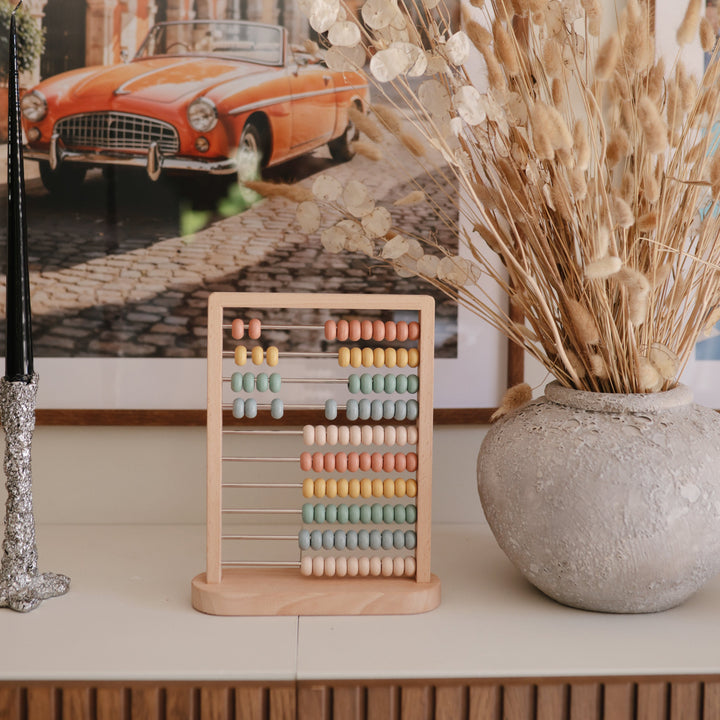 Child with the Mushie wooden abacus