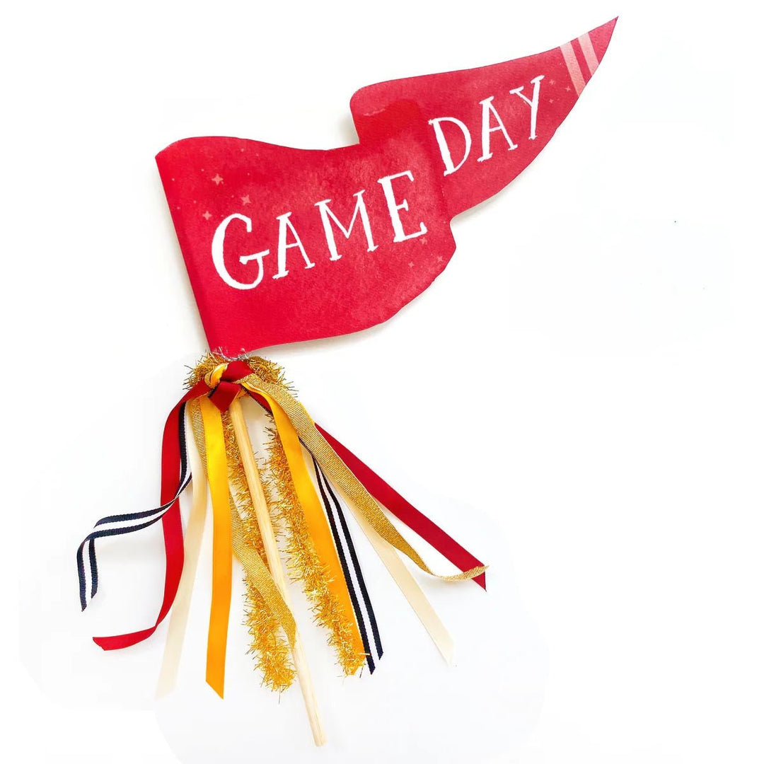 Red watercolor Game Day pennant flag with red, gold, and navy ribbons and gold tinsel on a wood dowel