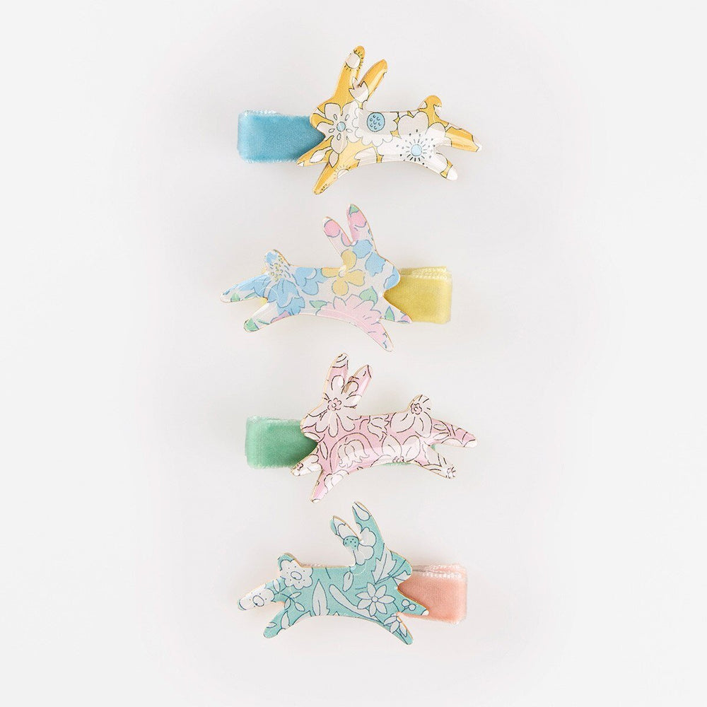 Four leaping bunny hair clips in pastel Liberty floral prints with blue, yellow, mint and peach velvet ribbons.