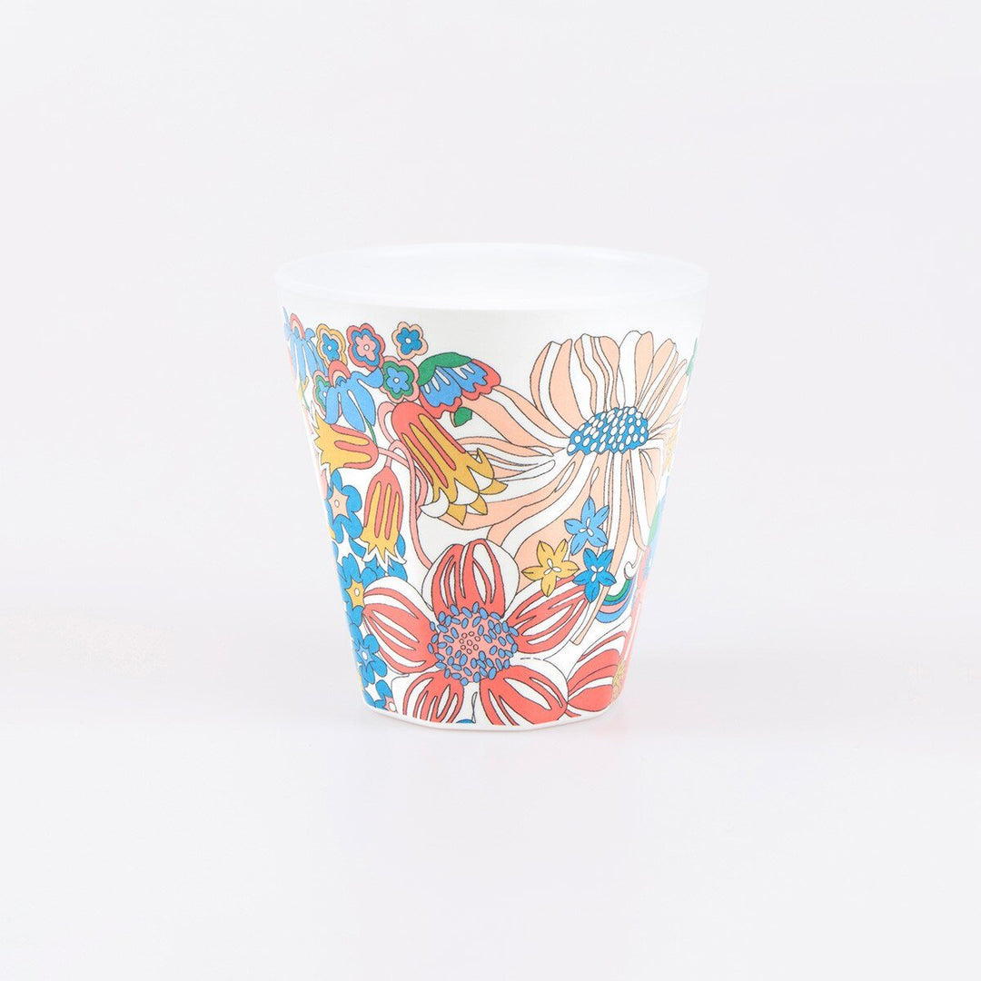 Single white reusable melamine cup with large peach, coral, blue and yellow Liberty flowers.