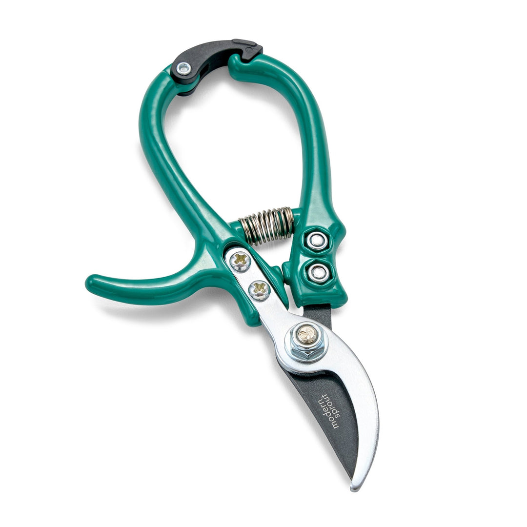 Ocean green bypass pruners with closed curved blades and a coil spring on white