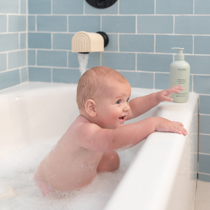 Mushie Dino Bath Essentials Kit components — quality silicone bath tools with dinosaur design