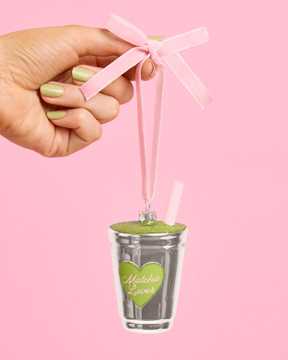 Another view of the matcha latte ornament, with its green glitter top and pale pink straw.