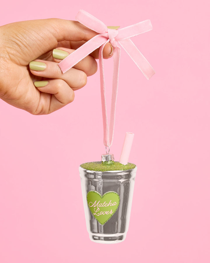 Another view of the matcha latte ornament, with its green glitter top and pale pink straw.