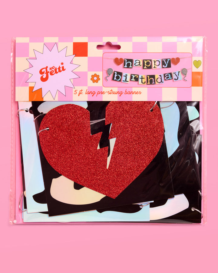 Emo happy birthday banner in retail packaging with a red glitter broken heart