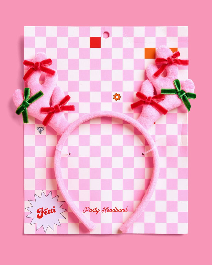 Pink reindeer antlers headband on its pink checkered party headband card