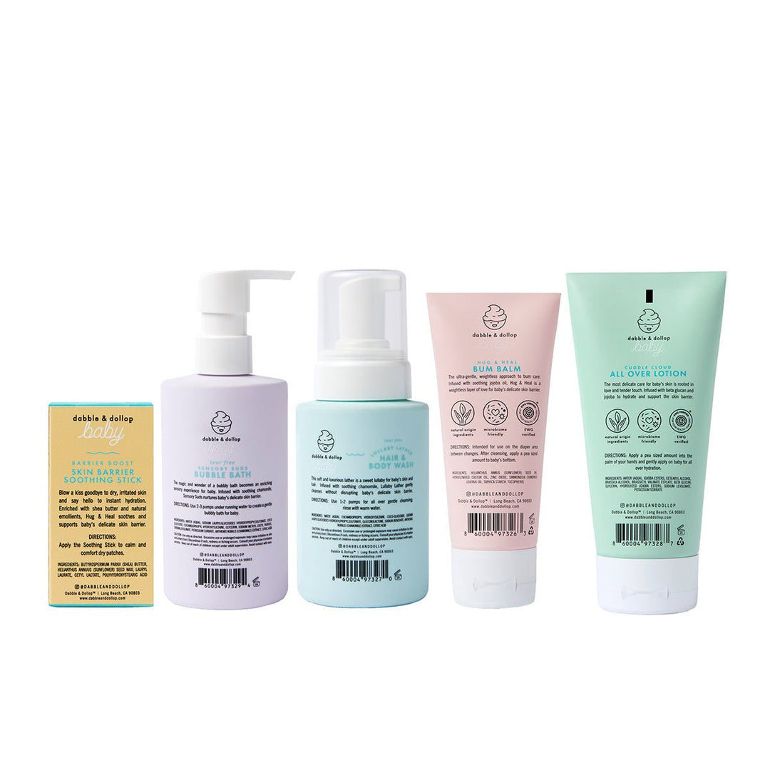 Back labels of the baby bath bottles, tubes, and soap bar lined up on white