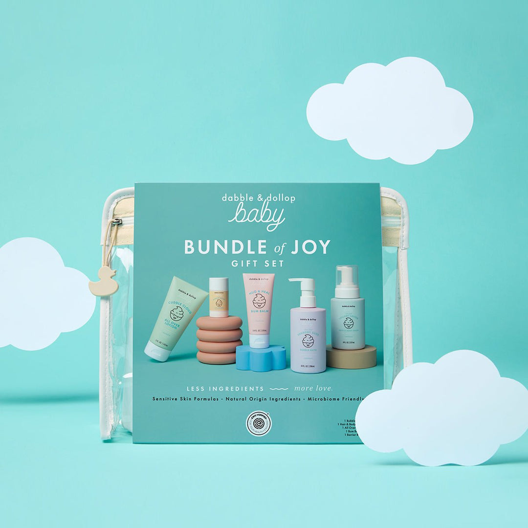 Bundle of Joy baby gift pouch styled on an aqua backdrop with white paper clouds