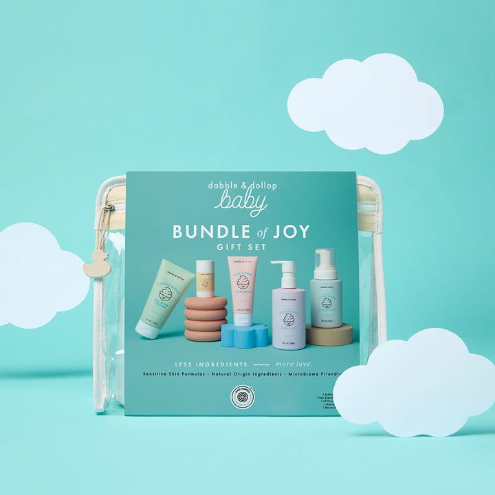 Bundle of Joy baby gift pouch styled on an aqua backdrop with white paper clouds