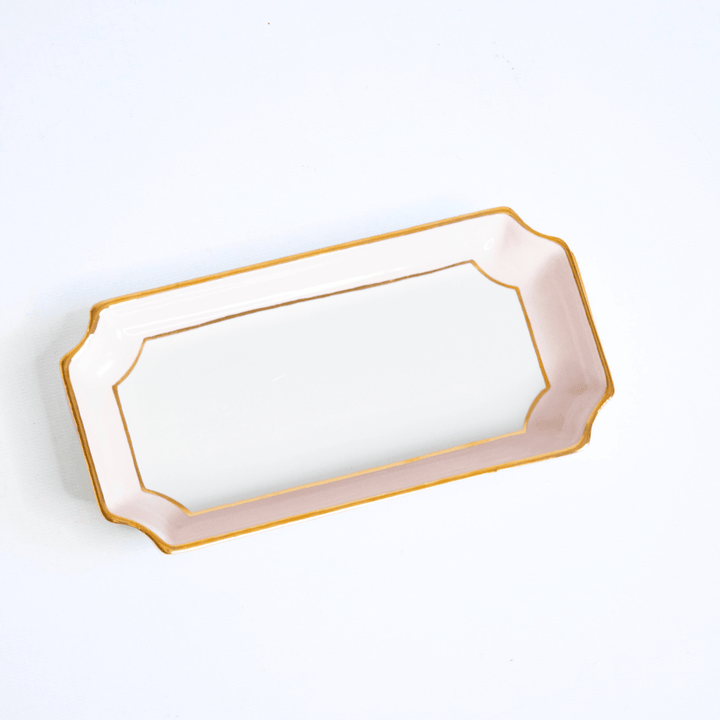 Rectangular ceramic tray with gold trim on a white background