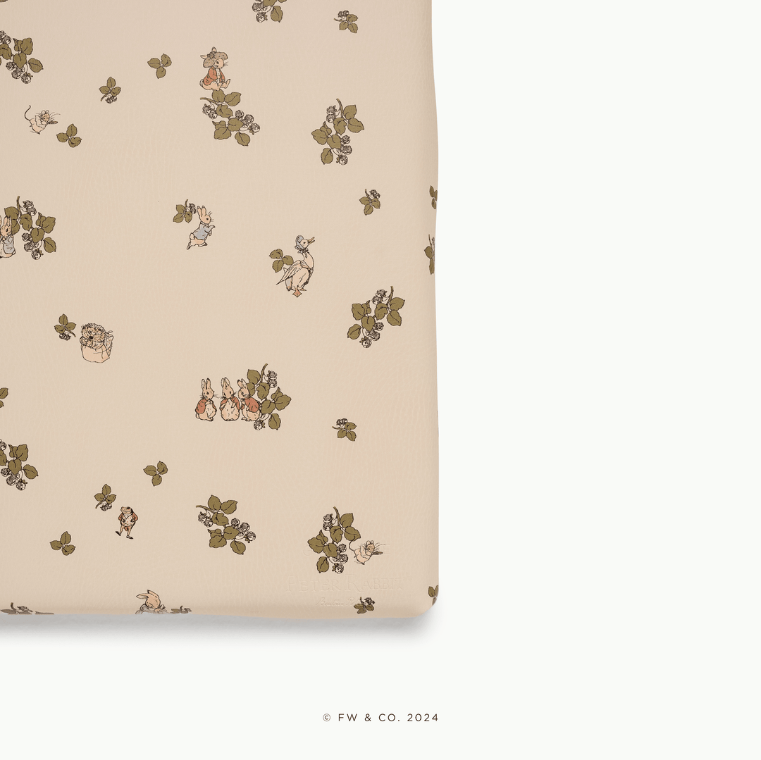 Close-up of the Peter Rabbit print showing Peter Rabbit, Jemima Puddle-Duck, and blackberry branches on the padded play mat