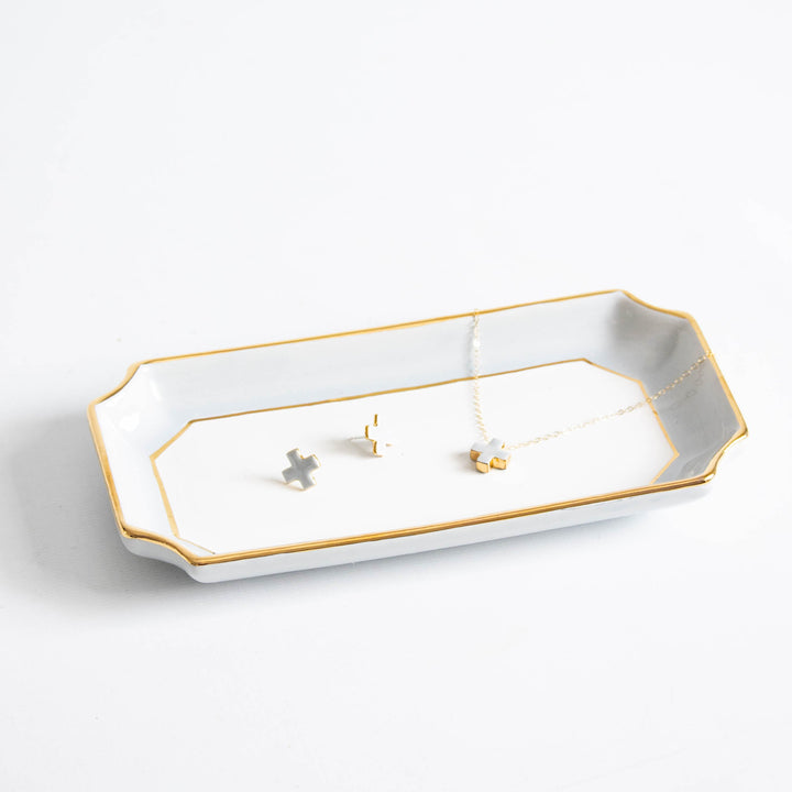 Light gray petite valet tray with gold trim holding small earrings and a fine chain, a dresser catchall gift