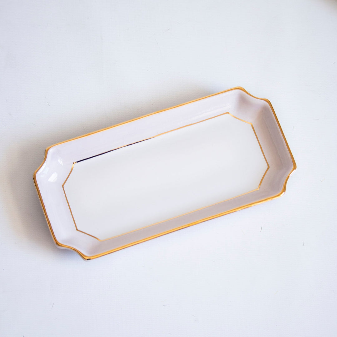 Pale blush petite valet tray with gold trim at an angle on a soft gray backdrop, a lovely Mother's Day gift