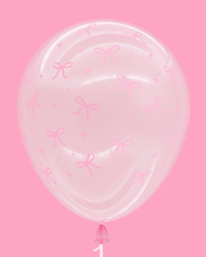 Single clear latex balloon with a pink bow print