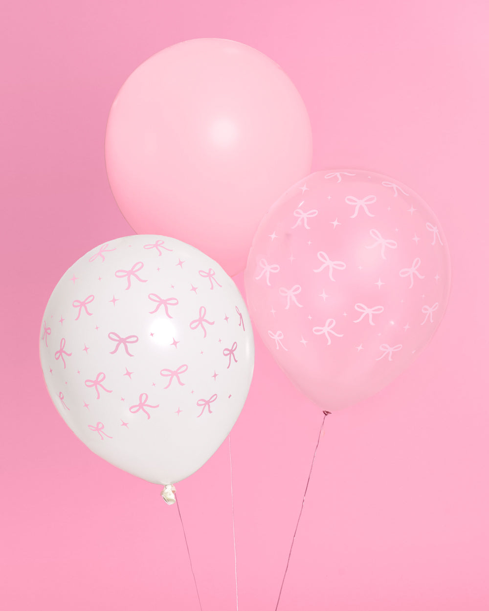 Detail of light pink and white pink bow latex balloons